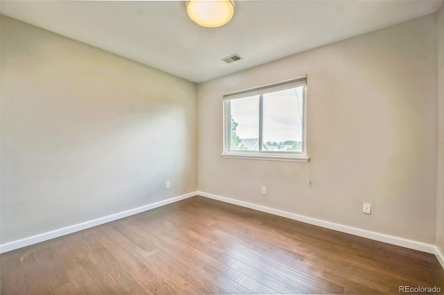 2446 S Gibralter Way, Aurora, CO 80013 - spare room with baseboards and hardwood / wood-style flooring