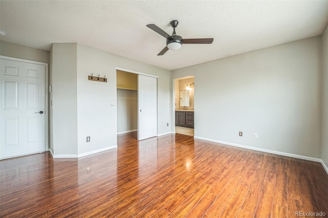 2446 S Gibralter Way, Aurora, CO 80013 - unfurnished bedroom with wood finished floors, a closet, a textured ceiling, and a ceiling fan