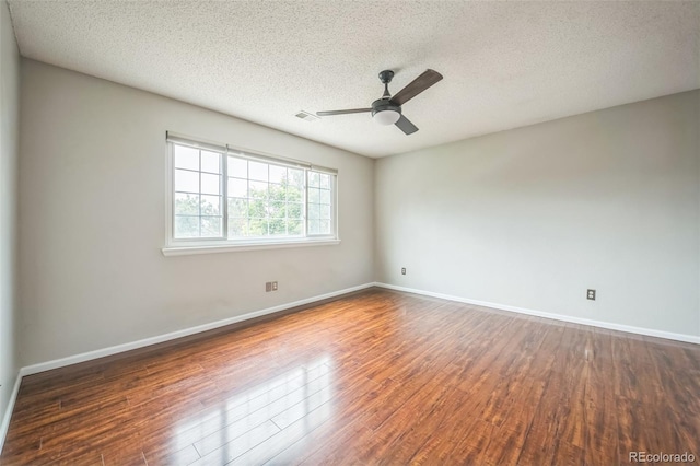 2446 S Gibralter Way, Aurora, CO 80013 - spare room featuring a textured ceiling, wood finished floors, and ceiling fan