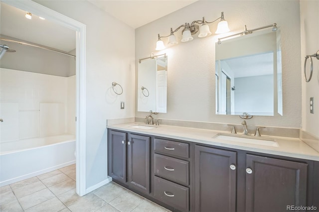 2446 S Gibralter Way, Aurora, CO 80013 - bathroom with double vanity, tile patterned floors, and shower / tub combination