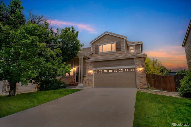 2446 S Gibralter Way, Aurora, CO 80013 - traditional-style house featuring brick siding, an attached garage, and concrete driveway