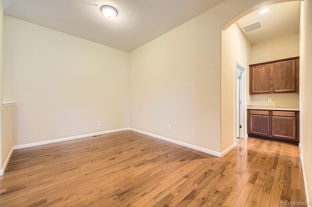 16550 Antero Cir, Broomfield, CO 80023 - empty room featuring arched walkways and light wood-style flooring
