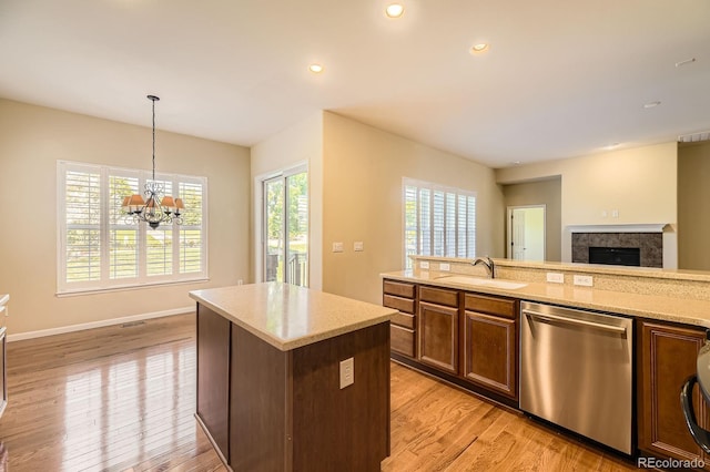 16550 Antero Cir, Broomfield, CO 80023 - kitchen featuring stainless steel dishwasher, light wood-style flooring, a center island, a chandelier, and hanging light fixtures