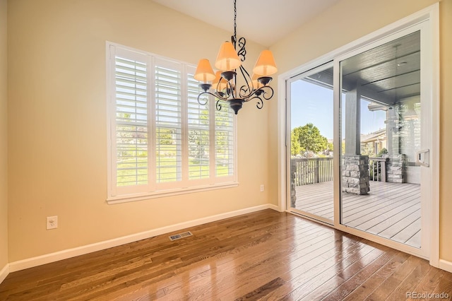 16550 Antero Cir, Broomfield, CO 80023 - unfurnished dining area with hardwood / wood-style flooring, healthy amount of natural light, a chandelier, and lofted ceiling