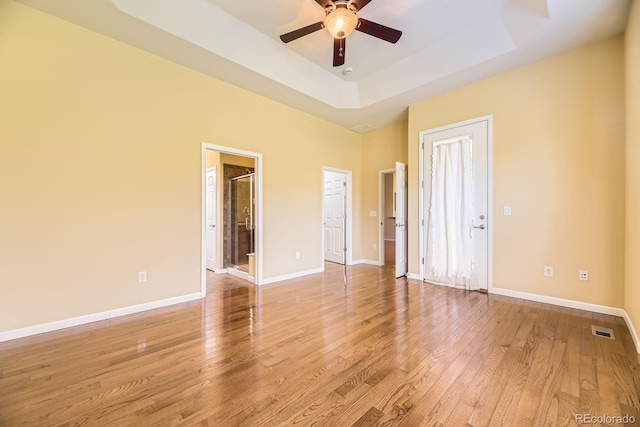16550 Antero Cir, Broomfield, CO 80023 - unfurnished bedroom with light wood-type flooring, a tray ceiling, ensuite bathroom, and a ceiling fan