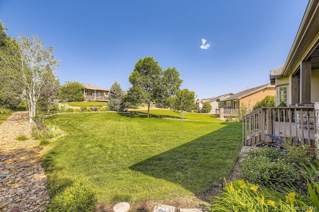 16550 Antero Cir, Broomfield, CO 80023 - view of green lawn featuring a wooden deck and a residential view