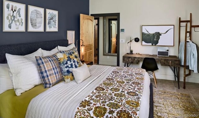 bedroom with tile patterned flooring and baseboards