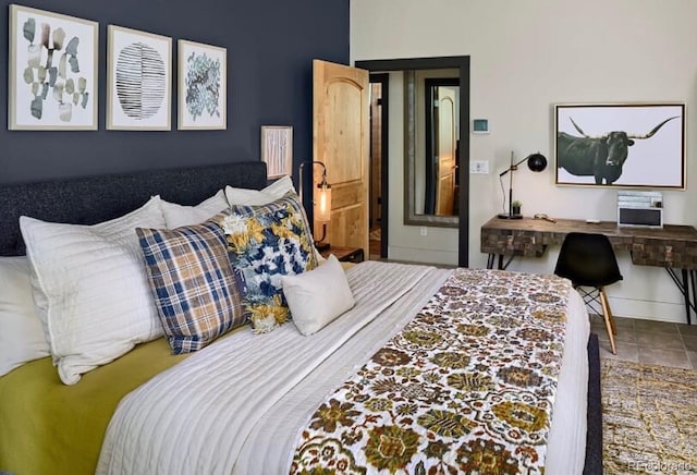 bedroom with baseboards and tile patterned floors