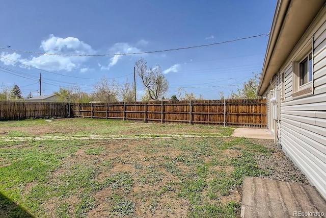 view of yard with a fenced backyard