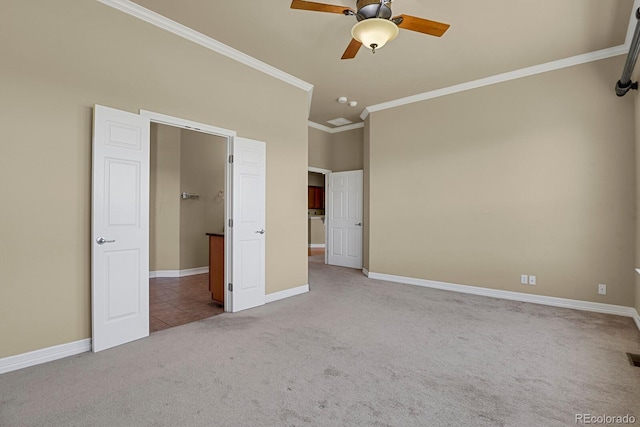 1975 Wild Star Way, Castle Rock, CO 80104 - unfurnished bedroom featuring carpet flooring, crown molding, baseboards, and ceiling fan