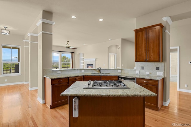 1975 Wild Star Way, Castle Rock, CO 80104 - kitchen with appliances with stainless steel finishes, tasteful backsplash, light wood-style flooring, and recessed lighting