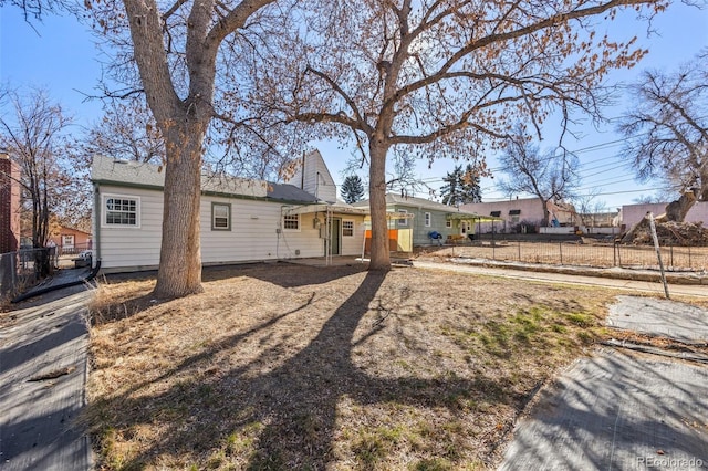 rear view of property featuring fence