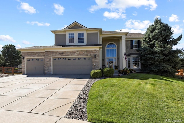 view of front of home featuring driveway, stone siding, a front yard, and fence