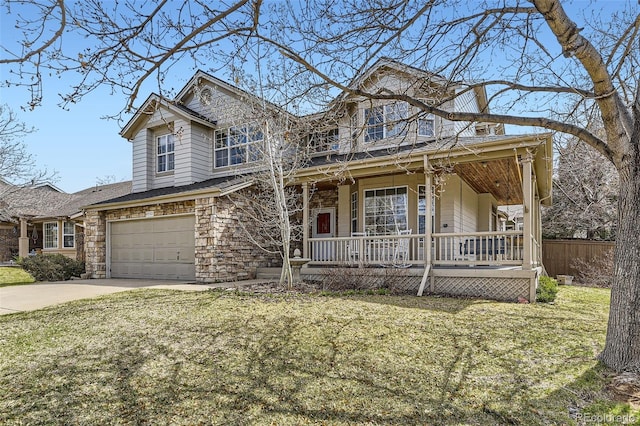 view of front facade with a porch, a garage, a front yard, and driveway