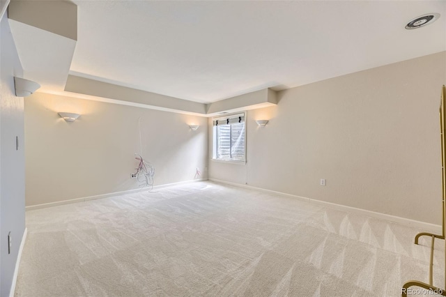 carpeted spare room with baseboards