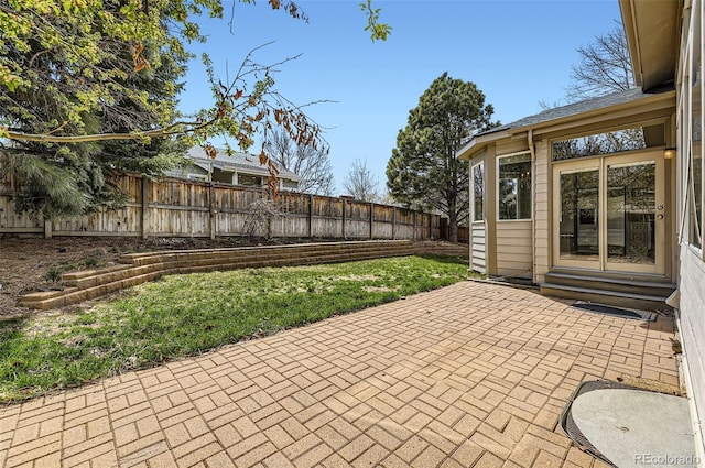 view of patio featuring entry steps and a fenced backyard