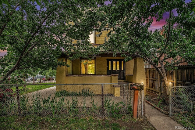 7 Elati St, Denver, CO 80223 - view of front of house with stucco siding and french doors
