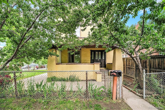 7 Elati St, Denver, CO 80223 - view of front of property with stucco siding and a fenced front yard
