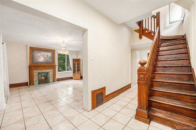 7 Elati St, Denver, CO 80223 - staircase featuring tile patterned flooring, a chandelier, and a tiled fireplace