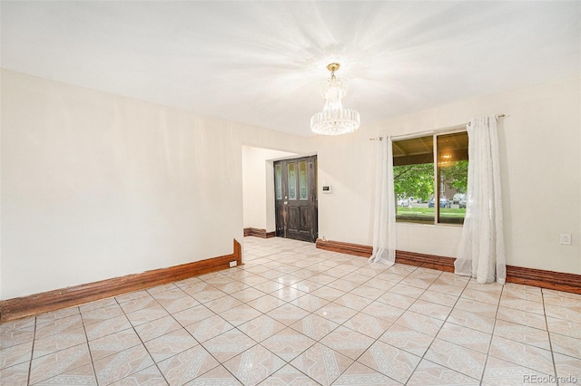 7 Elati St, Denver, CO 80223 - empty room featuring a chandelier and light tile patterned flooring