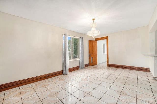 7 Elati St, Denver, CO 80223 - spare room with a chandelier and light tile patterned floors