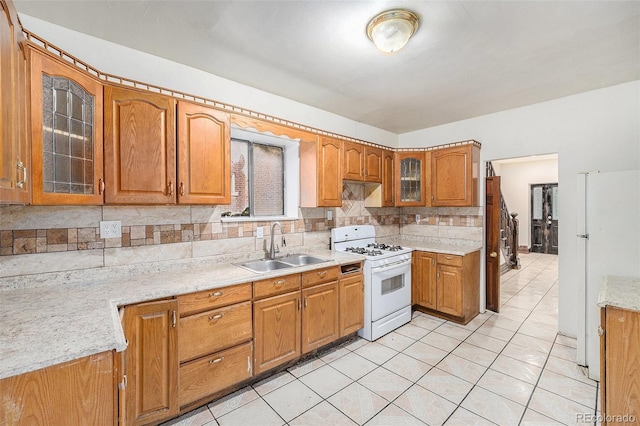 7 Elati St, Denver, CO 80223 - kitchen with white appliances, backsplash, brown cabinets, glass insert cabinets, and light tile patterned flooring