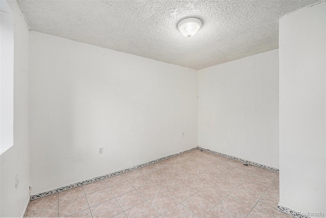 7 Elati St, Denver, CO 80223 - unfurnished room featuring a textured ceiling and light tile patterned floors