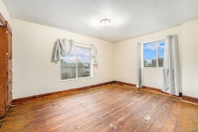 7 Elati St, Denver, CO 80223 - empty room with hardwood / wood-style flooring and baseboards