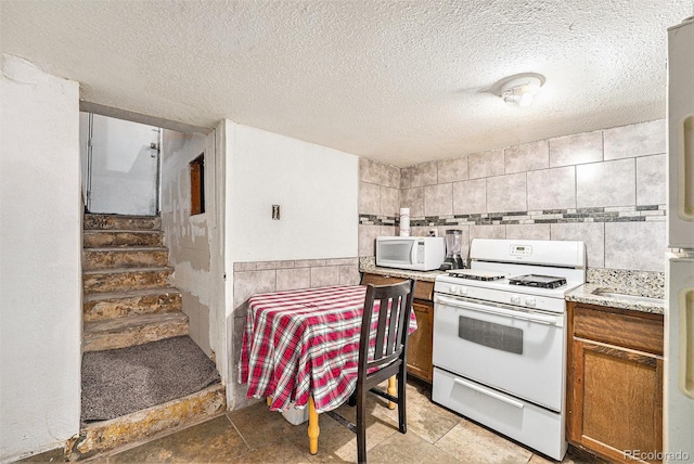 7 Elati St, Denver, CO 80223 - kitchen featuring white appliances, brown cabinets, light countertops, and a textured ceiling