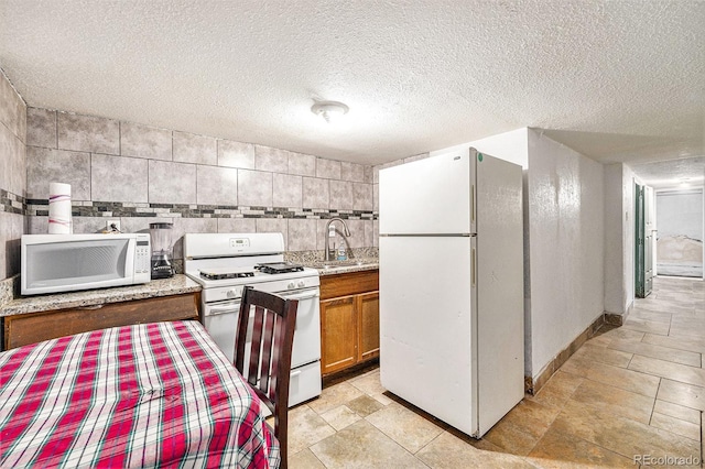 7 Elati St, Denver, CO 80223 - kitchen with white appliances, brown cabinets, and a textured ceiling