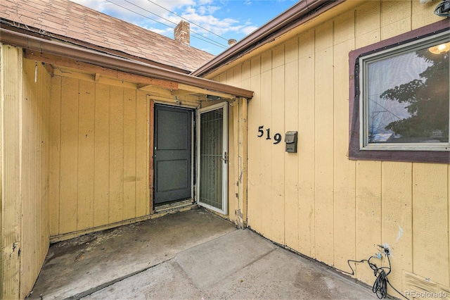 7 Elati St, Denver, CO 80223 - entrance to property with a patio, roof with shingles, and a chimney