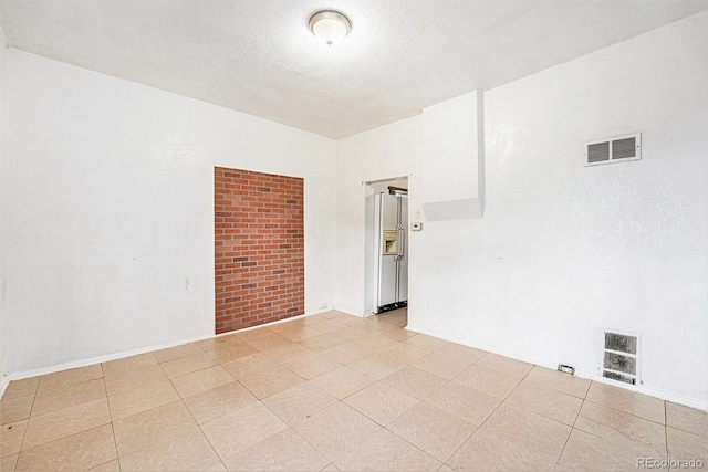 7 Elati St, Denver, CO 80223 - spare room with light tile patterned flooring and a textured ceiling