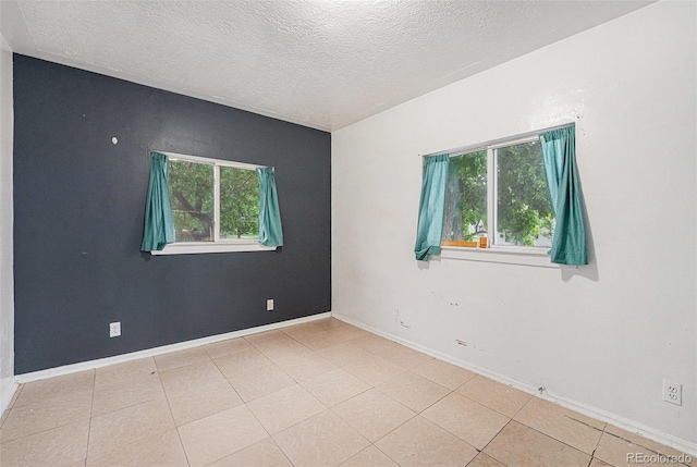 7 Elati St, Denver, CO 80223 - empty room with a textured ceiling and light tile patterned flooring