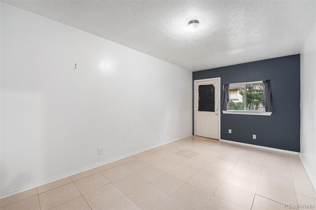 7 Elati St, Denver, CO 80223 - unfurnished room with a textured ceiling and baseboards