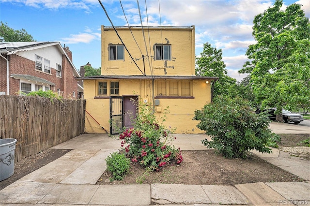 7 Elati St, Denver, CO 80223 - back of house with stucco siding and a gate