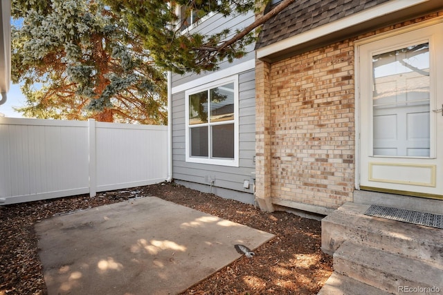 property entrance featuring a patio area