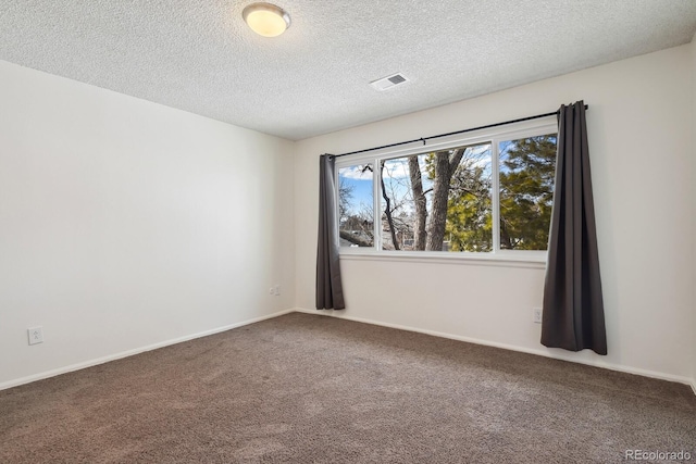 carpeted spare room featuring a textured ceiling