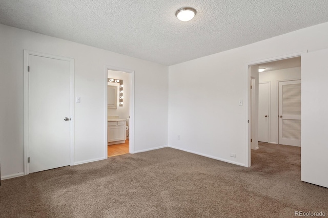 carpeted empty room with a textured ceiling