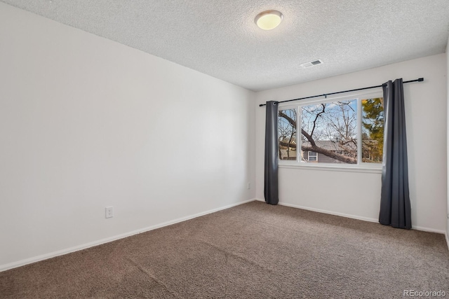 carpeted spare room featuring a textured ceiling