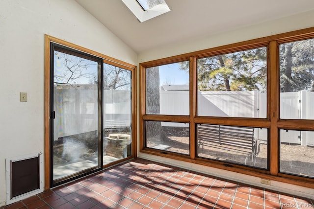 unfurnished sunroom with vaulted ceiling with skylight