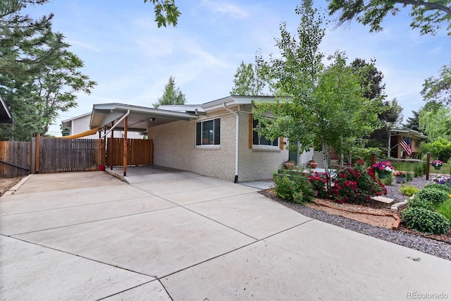 250 W Midway Blvd, Broomfield, CO 80020 - view of front of house featuring an attached carport, driveway, and brick siding