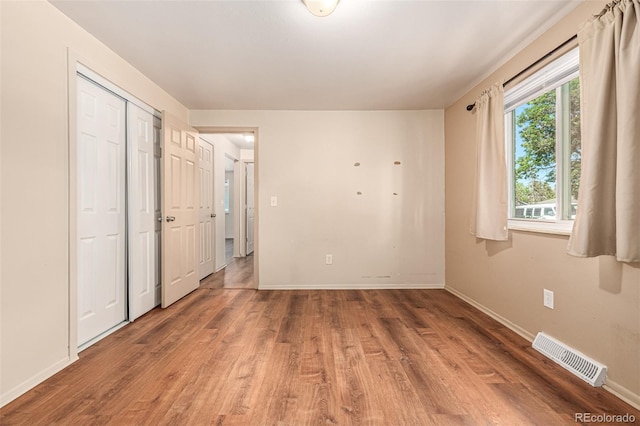 unfurnished bedroom with wood-type flooring