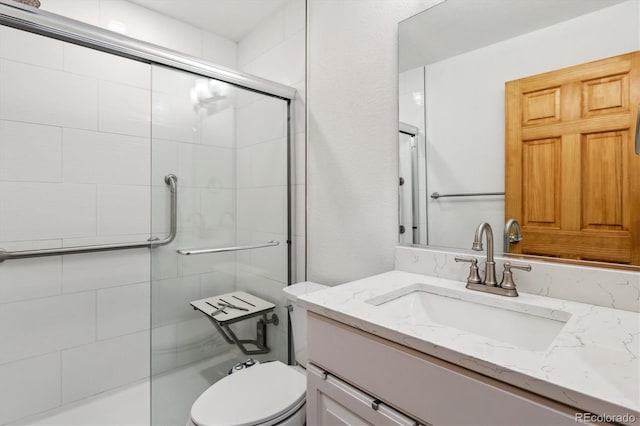 6508 S Garland Way, Littleton, CO 80123 - bathroom featuring an enclosed shower and vanity