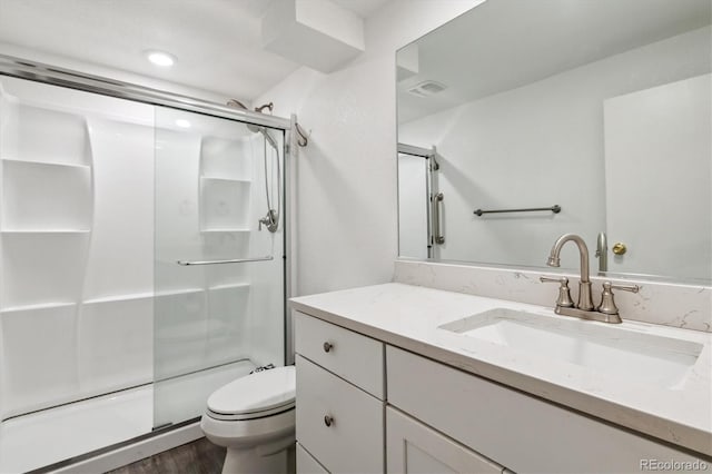 6508 S Garland Way, Littleton, CO 80123 - bathroom featuring vanity, a stall shower, and wood finished floors