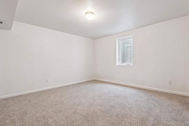 6508 S Garland Way, Littleton, CO 80123 - carpeted empty room featuring baseboards and a textured ceiling