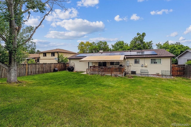 6508 S Garland Way, Littleton, CO 80123 - rear view of property featuring solar panels and a fenced backyard