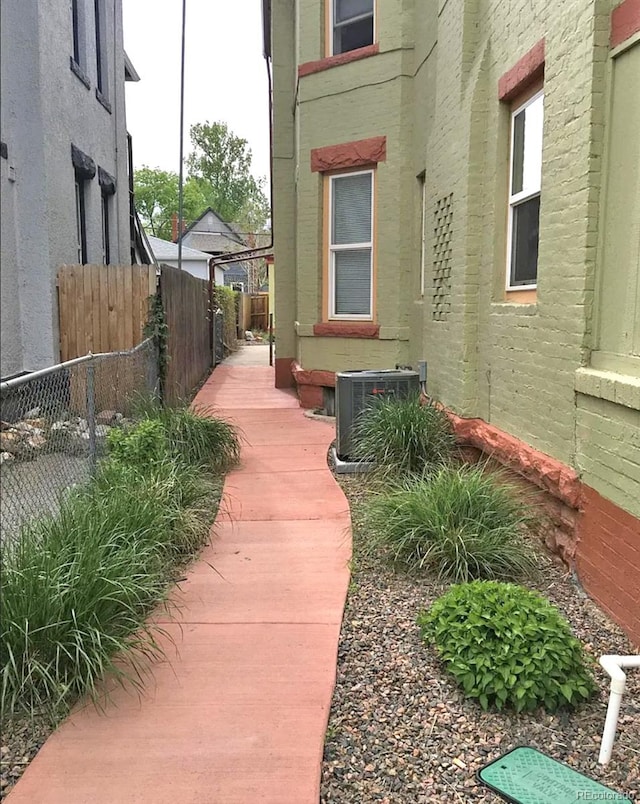 view of side of property with central air condition unit