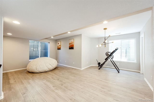 4970 Laurelglen Ln, Highlands Ranch, CO 80130 - workout room with baseboards, light wood-style floors, recessed lighting, and a chandelier