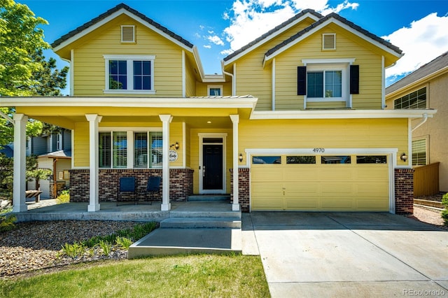 4970 Laurelglen Ln, Highlands Ranch, CO 80130 - view of front of house featuring brick siding, a porch, driveway, and an attached garage