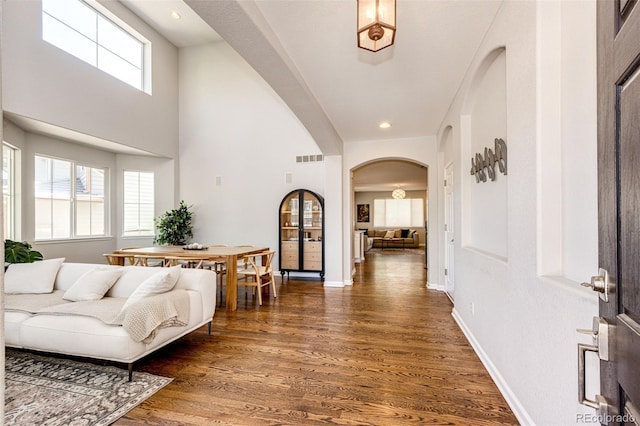4970 Laurelglen Ln, Highlands Ranch, CO 80130 - entrance foyer with arched walkways, wood finished floors, plenty of natural light, recessed lighting, and baseboards